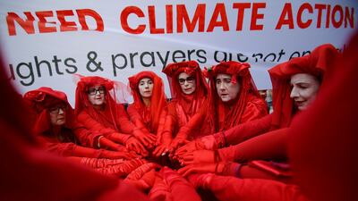 Red Rebels from Extinction Rebellion are seen during a School Strike for Climate Australia (SS4C) 'Solidarity Sit-down' outside of the office of the Liberal Party of Australia in Sydney, Australia, November 29, 2019. REUTERS