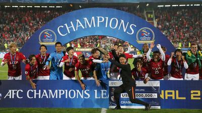 Kashima Antlers manager Go Oiwa holds up the Asian Champions League trophy. AP Photo