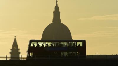 A bus carries commuters as it travels over Waterloo Bridge in London, Britain. Toby Melville / Reuters