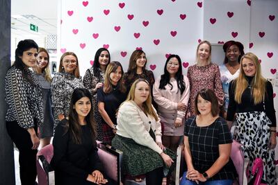 Natasha Hatherall-Shawe, owner of TishTash, centre, with her team of 20 female employees at their office in Dubai Media City UAE. Shruti Jain for The National