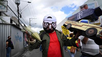 An opponent of the government of Salvadoran President Nayib Bukele during a protest against Mr Bukele's security policies, during El Salvador's 201st anniversary of independence in San Salvador. AFP