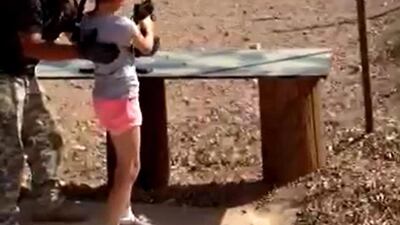 Shooting instructor Charles Vacca standing next to a 9-year-old girl moments before the accident at the Last Stop shooting range in White Hills, Arizona on August 25, 2014 in this still image taken from video. The girl accidentally shot and killed her shooting instructor with an Israeli-made Uzi submachine gun when the weapon's strong recoil caused her to lose control of her aim. Mohave County Sheriff's Office/Handout via Reuters