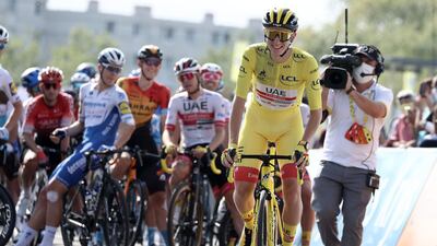 Team UAE Emirates rider Slovenia's Tadej Pogacar wearing the overall leader's yellow jersey attends the start of the 21st and last stage of the 107th edition of the Tour de France cycling race, 122 km between Mantes-la-Jolie and Champs Elysees Paris. AFP