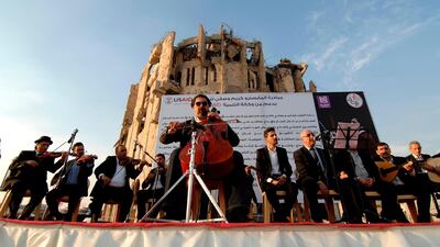 Renowned Iraqi maestro and cello player Karim Wasfi performs in Mosul’s war-ravaged Old City. AFP