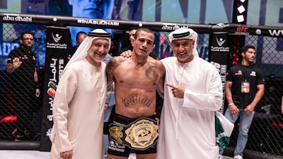 Bruno Machado is joined by Saleh Al Geziry (left), director general of Tourism at Department of Culture and Tourism Abu Dhabi, and Abdulmunam Al Hashemi, chairman of Palms Sports, after his win in the UAE Warriors lightweight match. All photos: UAE Warriors