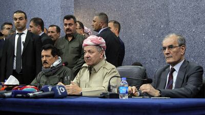Iraqi Kurdistan president Masoud Barzani, centre, and Najim Karim, right, the governor of Kirkuk who was sacked by parliament, at a meeting between representatives of the peshmerga and Arab, Kurdish, and Iraqi Turkmen tribal leaders in Kirkuk city on September 12, 2017. Marwan Ibrahim / AFP