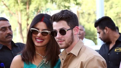 Priyanka Chopra and Nick Jonas pose for photographs as they leave Jodhpur after their wedding weekend. Photo: EPA