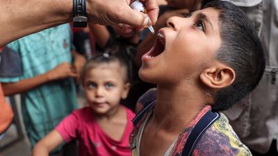 A child receives a polio vaccination drop in Deir Al Balah in the central Gaza Strip on Wednesday. AFP