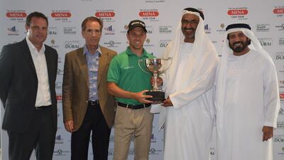 Gary King receives the winner’s trophy from Khalfan Al Kaabi, chairman of the Ascorp Holdings, as Mohamed Juma Bumaim, chairman of the Mena Golf Tour, Mark Chapleski, senior vice president of Troon Golf, and Scott McCaw, Director of Club Operations, look on at Saadiyat Beach Golf Club. Courtesy: Mena Golf Tour