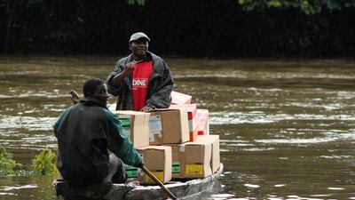 Volunteers transporting vital goods on boats in Liberia.