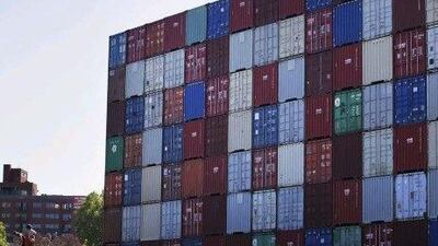The letters 'IOU' spelled out on shipping containers stands across from the Federal Reserve Bank of Kansas City. Orlin Wagner / AP Photo
