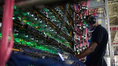 A technician monitors cryptocurrency mining rigs in Quebec, Canada. Bloomberg