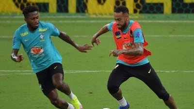 Brazil's Neymar vies for the ball with Fred during a training session. AFP