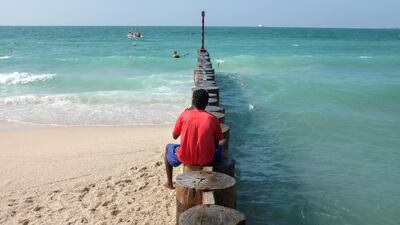 A beach-goer takes in the serene views during a visit to Kite Beach. Antonie Robertson/The National