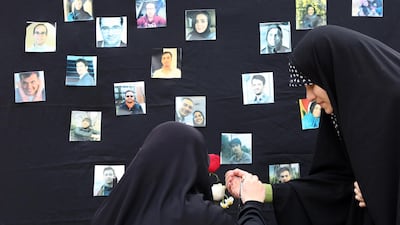 Students light candles during a memorial ceremony for passengers of Ukraine airplane, at the Tehran university in Iran. EPA