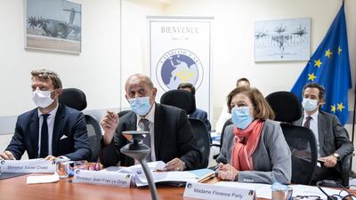 French Foreign Minister Jean-Yves Le Drian (centre) and French Defence Minister Florence Parly (right) take part in a video meeting on the Kabul crisis at the French military air base of Al Dhafra, near Abu Dhabi, on August 23. AFP