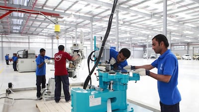 Workers at the Armoured Protection Glass facility for Streit Group, the world’s leading manufacturer of armoured vehicles, in Ras Al Khaimah. The UAE aims to further increase its manufacturing exports to diversify the economy away from dependence on oil and gas. Sarah Dea / The National