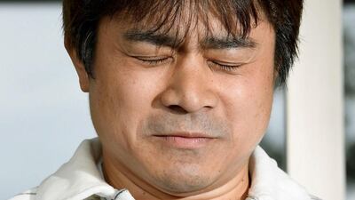 Takayuki Tanooka, father of Yamato Tanooka reacts as he speaks to the media in Hokkaido. Kyodo via Reuters