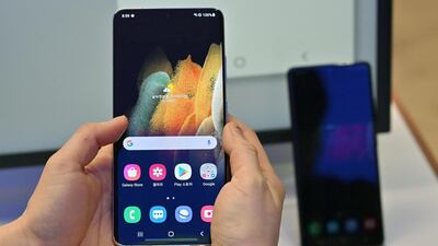 A visitor looks at the Samsung Galaxy S21 smartphone during a domestic launch event at a flagship store of SK Telecom in Seoul on January 22, 2021. (Photo by Jung Yeon-je / AFP)