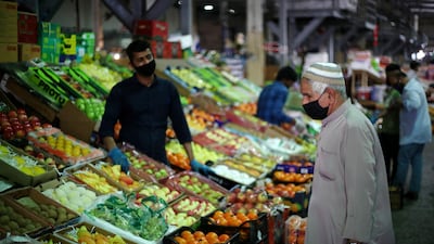 A Bahraini man wears a protective face mask following the outbreak of the coronavirus disease, as he shops at a vegetables market. Reuters