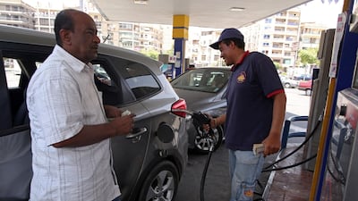 A petrol station attendant fuels a car at a gas station in Cairo. The Egyptian government increased the price of gasoline by at least 42.8 per cent as part of an economic reform programme. Khaled Elfiqi / EPA
