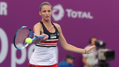 Karolina Pliskova of the Czech Republic returns the ball to Catherine Bellis of the US as they compete in their singles match during the third round of the Qatar Open in Doha. Karim Jaafar / AFP