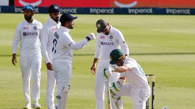 India players check on Dean Elgar after the South African batsman was hit on the helmet by a Jasprit Bumrah ball. Reuters
