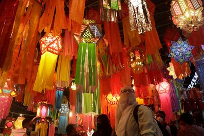 A woman looks at lanterns displayed in roadside stalls ahead of the Diwali festival in Mumbai. The global chip shortage has impacted sales of electronics and automobiles during the festival season. AP