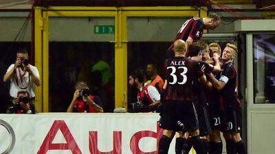 AC Milan's players celebrate after scoring during their Serie A win against AS Roma on Saturday. Giuseppe Cacae / AFP / May 9, 2015