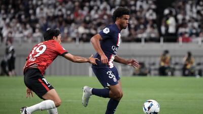 PSG teen Warren Zaire-Emery controls the ball under pressure from Ken Iwao of Urawa Red Diamonds. Getty