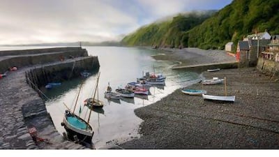 Boats moored in the harbour in Clovelly, a fishing village along the Devon coast. The National Trust offers well-maintained properties in picturesque locations across the UK. Adam Burton / Robert Harding