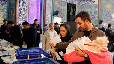 Iranian citizens cast their ballots at a polling station during the parliamentary elections in Tehran. EPA