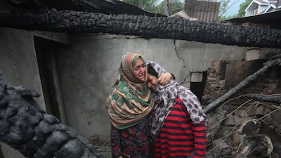 Kashmiri women grieve inside their house damaged after cross-border shelling from Pakistan, at Salamabad village in Uri, north of Srinagar. EPA