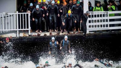 Swimmers jump into San Francisco Bay at the beginning of the Escape from Alcatraz Triathlon on Sunday. Noah Berger / Reuters / June 1, 2014