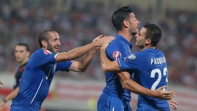 Italy's Manuel Pasqual, right, congratulates Graziano Pelle, centre, after he scores Italy's goal in a 1-0 win over Malta in Euro 2016 qualifying on Monday night in Malta. Matthew Mirabelli / AFP / October 13, 2014
