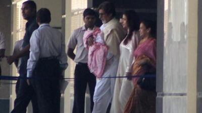 Amitabh Bachchan carries his new granddaughter out of Seven Hills hospital in Mumbai yesterday as the baby’s mother, Aishwarya Rai, follows. AFP
