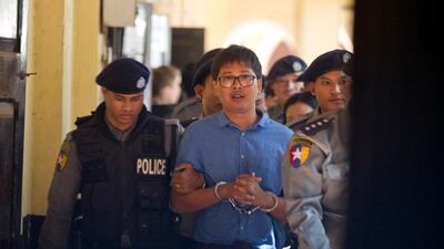 Reuters journalist Wa Lone is escorted by police as he leaves court on Wednesday, January 10, 2018, outside Yangon, Myanmar. Thein Zaw / AP
