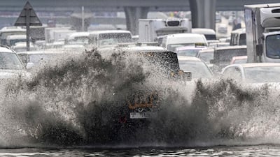 Vehicles drive on a flooded road during heavy rain in Dubai. AFP