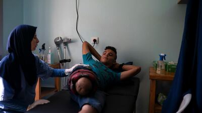 18-year-old Atalla Fayoumi, who had his leg amputated after he was shot in a demonstration in April, attends a physical therapy session in a clinic run by MSF (Doctors Without Borders) in Gaza City. Ever since Hamas launched demonstrations in March against Israel's blockade of Gaza, children have been a constant presence in the crowds. Since then, U.N. figures show that 948 children under 18 have been shot by Israeli forces and 2,295 have been hospitalized, including 17 who have had a limb amputated. AP