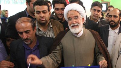 Mehdi Karroubi, who has been under house arrest, casts his ballot at a polling station in Tehran on June 12, 2009. AFP