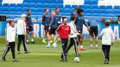 Head coach Pep Guardiola, centre, gestures during their FC Bayern Muenchen training at the Santiago Bernabeu Stadium ahead of the UEFA Champions League semi-final first leg match against Real Madridon April 22, 2014 in Madrid, Spain. Martin Rose/Getty Images