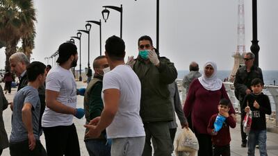 A municipal policeman, center, orders people to leave the waterfront promenade, along the Mediterranean Sea in Beirut. AP Photo