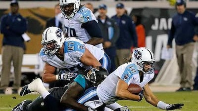 Tennessee Titans quarterback Charlie Whitehurst, right, is sacked by Jacksonville Jaguars' Sen'Derrick Marks on the final play of an NFL football game, Thursday, Dec. 18, 2014, in Jacksonville, Fla. Jacksonville won 21-13. (AP Photo/Stephen B. Morton)