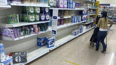 Shoppers left shelves half-empty in a Tesco supermarket in Old Kent Road in London on Tuesday as the UK announces new coronavirus restrictions. Stephen Lock for The National