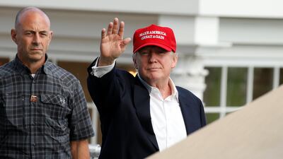 US president Donald Trump waves as he departs the US Women's Open golf tournament at the Trump National Golf Club in Bedminster, New Jersey on July 15, 2017. Kevin Lamarque / Reuters