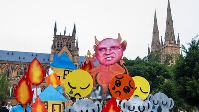Protesters hold up placards as activists rally for climate action in Hyde Park in Sydney, Australia. Getty Images