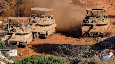 Israeli battle tanks deploy in a village in southern Lebanon on Sunday. AFP