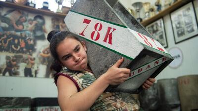Basque 'Harrijasotzaile' stone lifter Udane Ostolaza, 15, carries a large boulder during a training session in the Spanish Basque city of Orio. AFP
