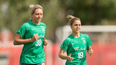 Australia's Kyah Simon, left, and Katrina Gorry jog during the team's practice session in Edmonton, Canada. Geoff Robins / AFP