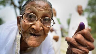 An elderly Indian woman shows her ink-marked finger after casting his vote in Jorhat constituency during the first phase of Assam Assembly election in Jorhat district of Assam state, India, on April 4, 2016 as thousands of voters went to the polls to elect 65 legislators. EPA